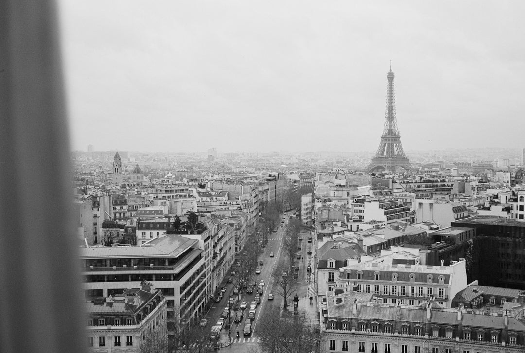 Analog photo print on Fujifilm paper featuring the Eiffel Tower as seen from the Arc de Triomphe in Paris on a winter day, captured in black and white film for a classic, timeless look.