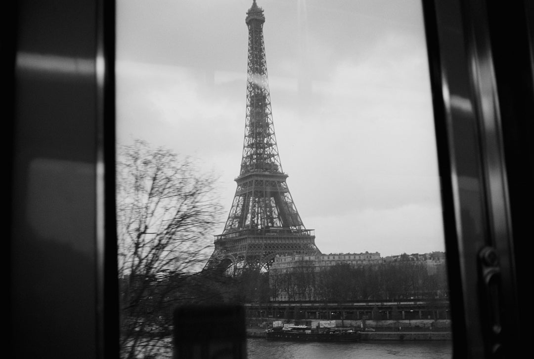 Analog photo print on Fujifilm paper featuring the Eiffel Tower as seen from Metro Line 6 above the Seine, captured in black and white film.