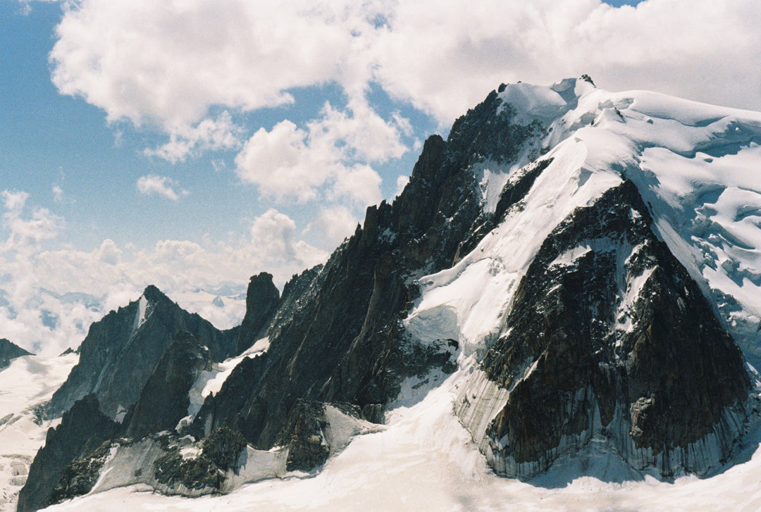 Analog photo print on Fujifilm paper featuring the towering peaks of the Mont Blanc massif, showcasing the rugged, snow-capped summits against the sky.