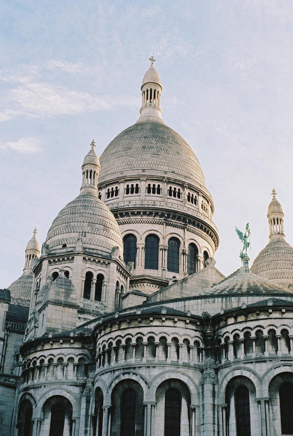 Analog photo print on Fujifilm paper featuring the towers of Sacré-Cœur in winter, bathed in sunlight with a clear blue sky above.