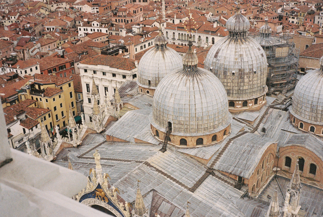 Analog photo print on Fujifilm paper featuring the domes of Basilica San Marco in Venice, captured from above, showcasing its intricate architecture and iconic design.